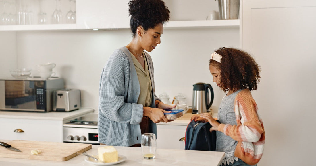 busy mom packing school lunch kitchen morning routine